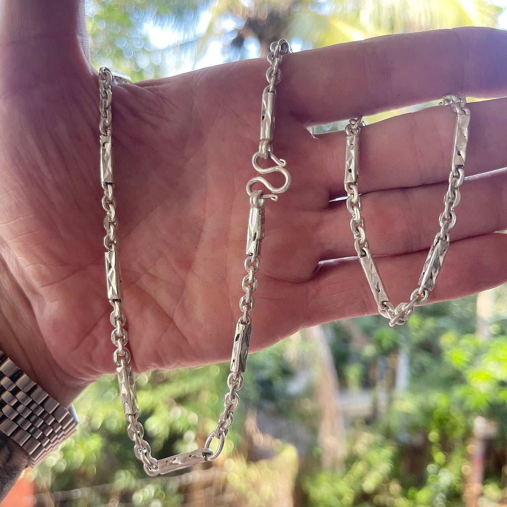 Solid silver Khmer sugarcane chain for men held in hand for scale