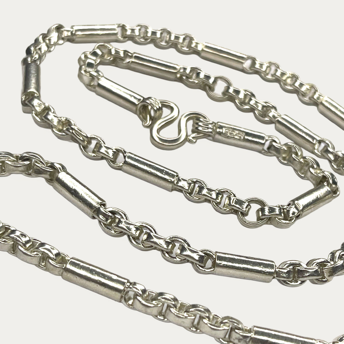 close up of round figaro belcher solid silver chain. gift for men