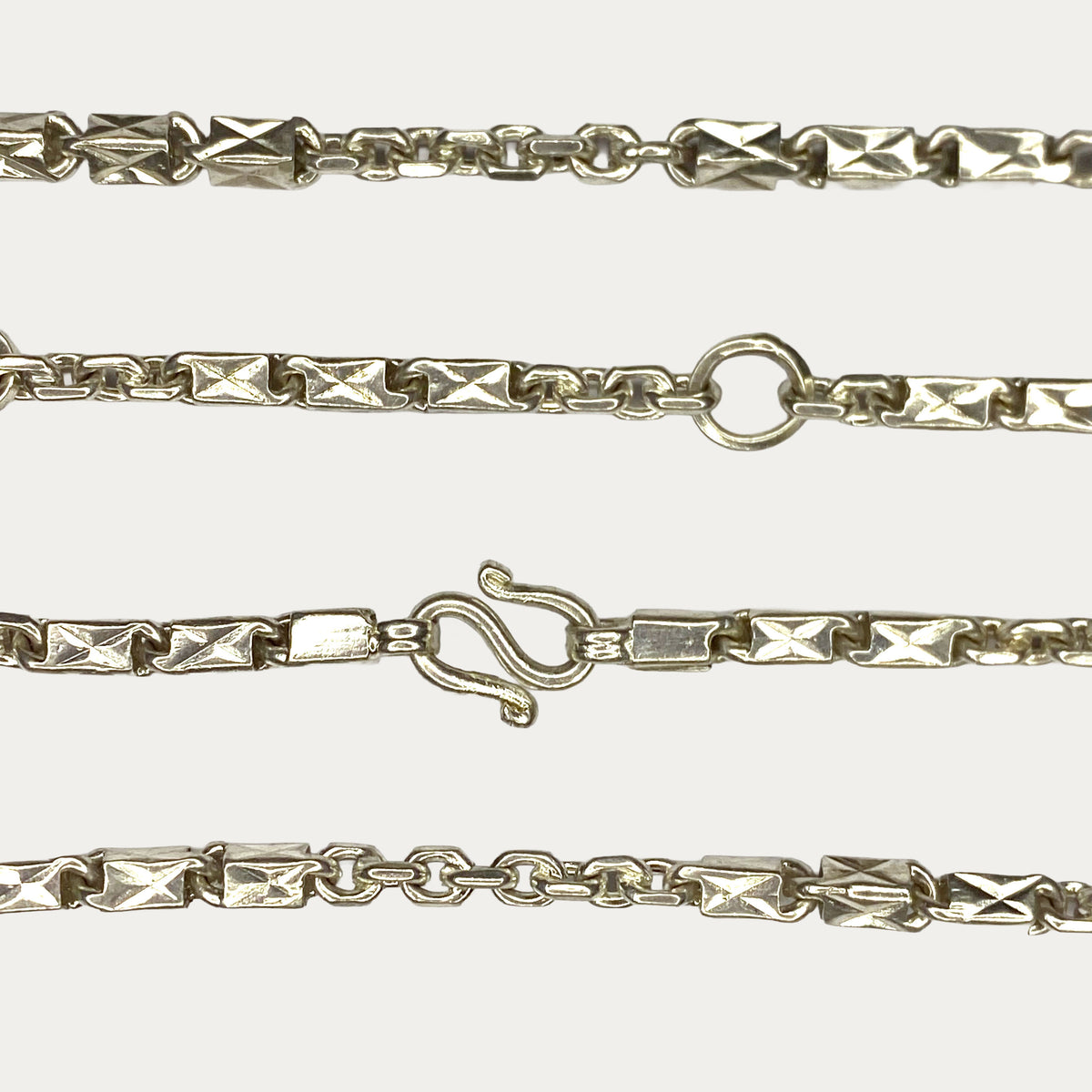 Close-up of Triple Bar Khmer Sugarcane link chain in solid silver