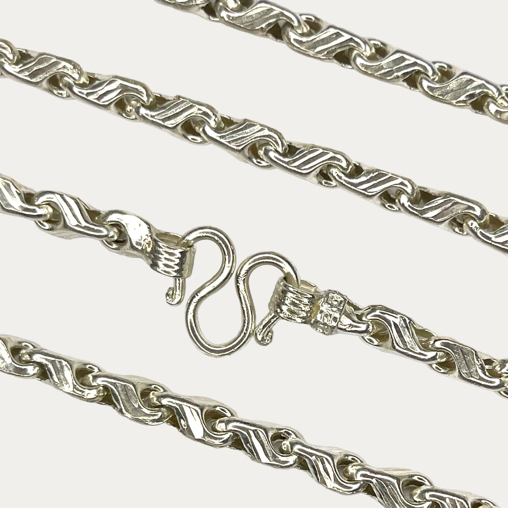Close-up of solid silver teardrop chain clasp and links 