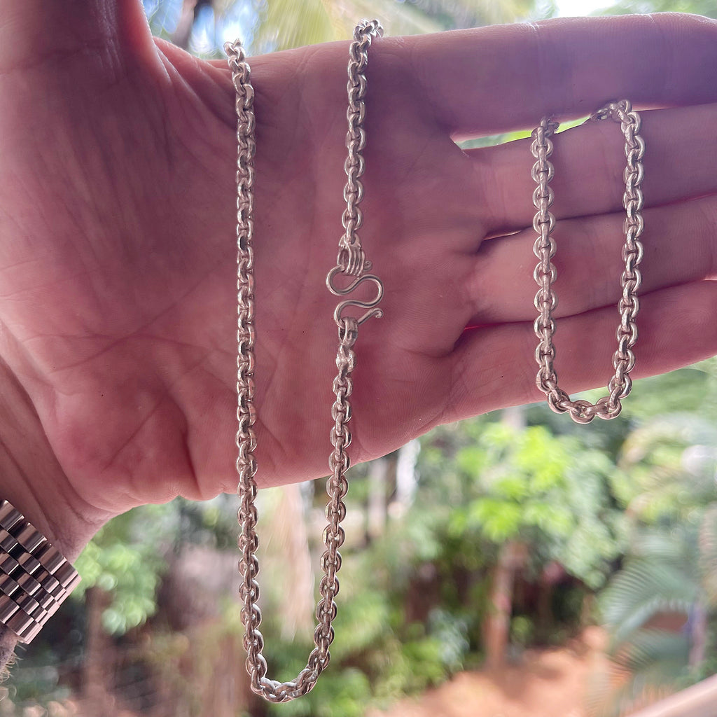 solid silver Anchor Belcher chain held in hand